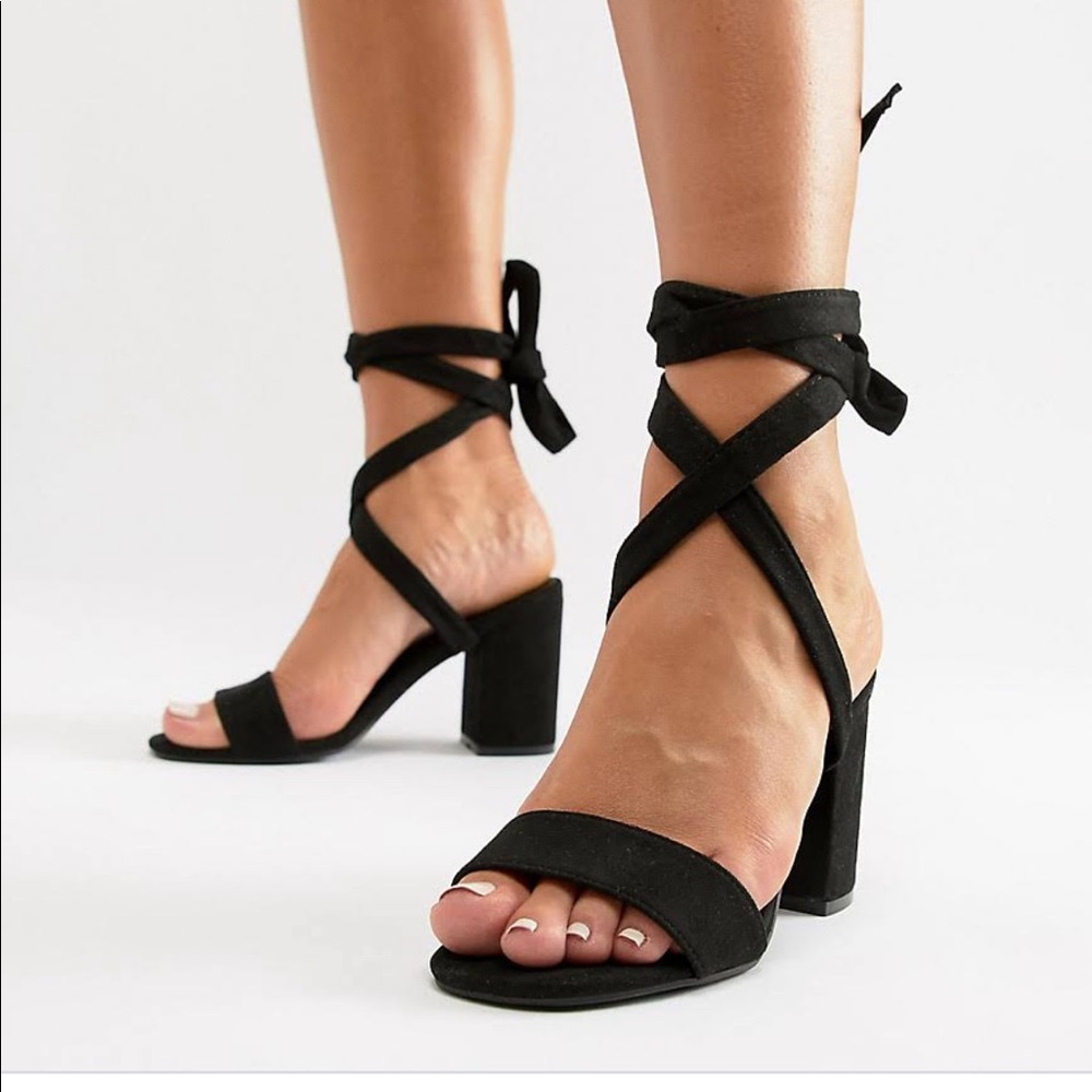 Report black block heel sandal with ankle tie.